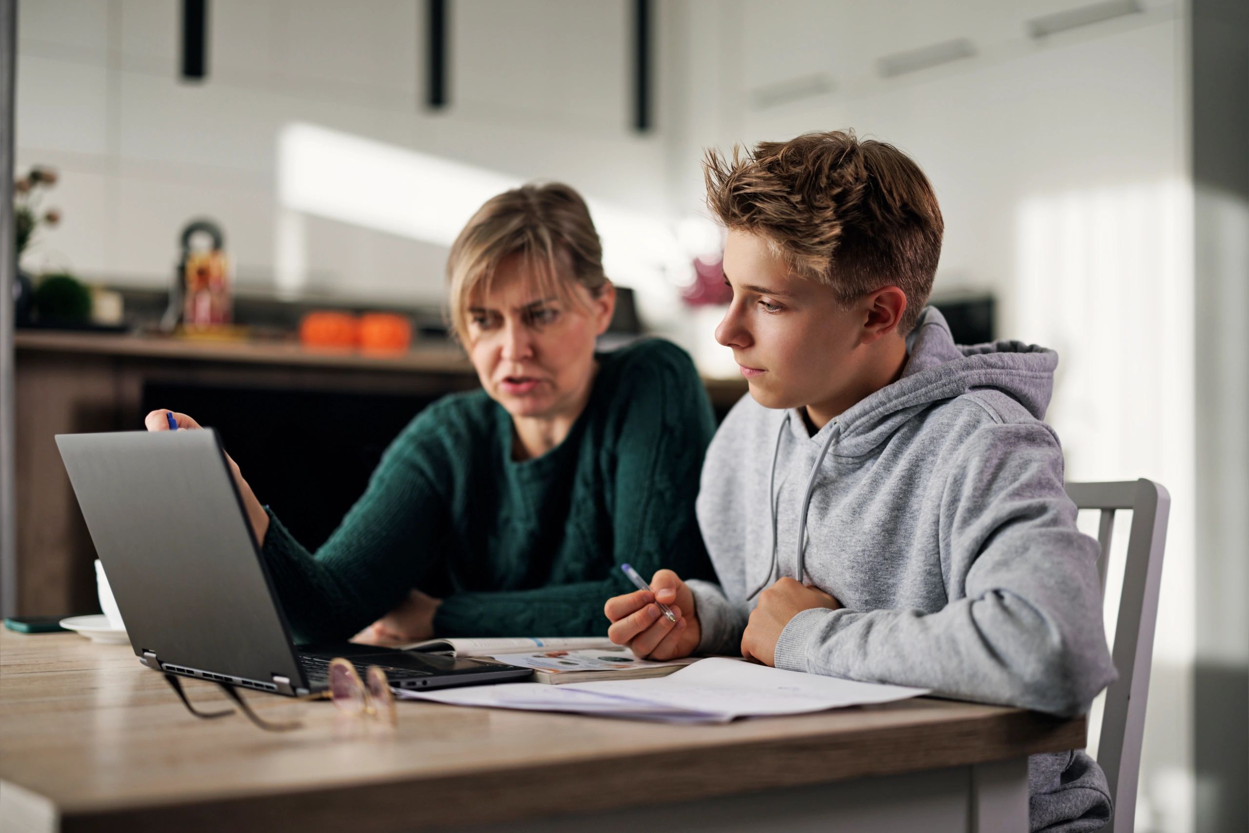 Parent helping a child with homeschool lessons at home