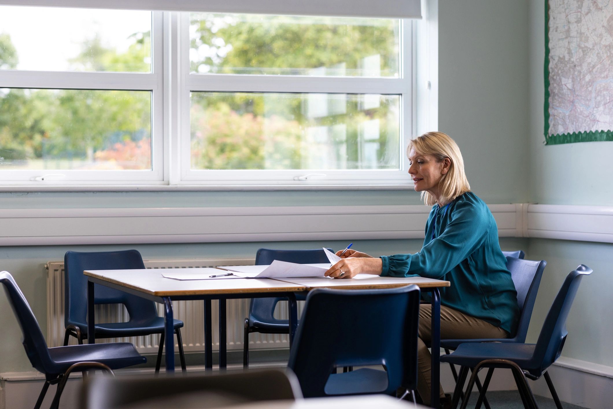 Educator reviewing student work at a table